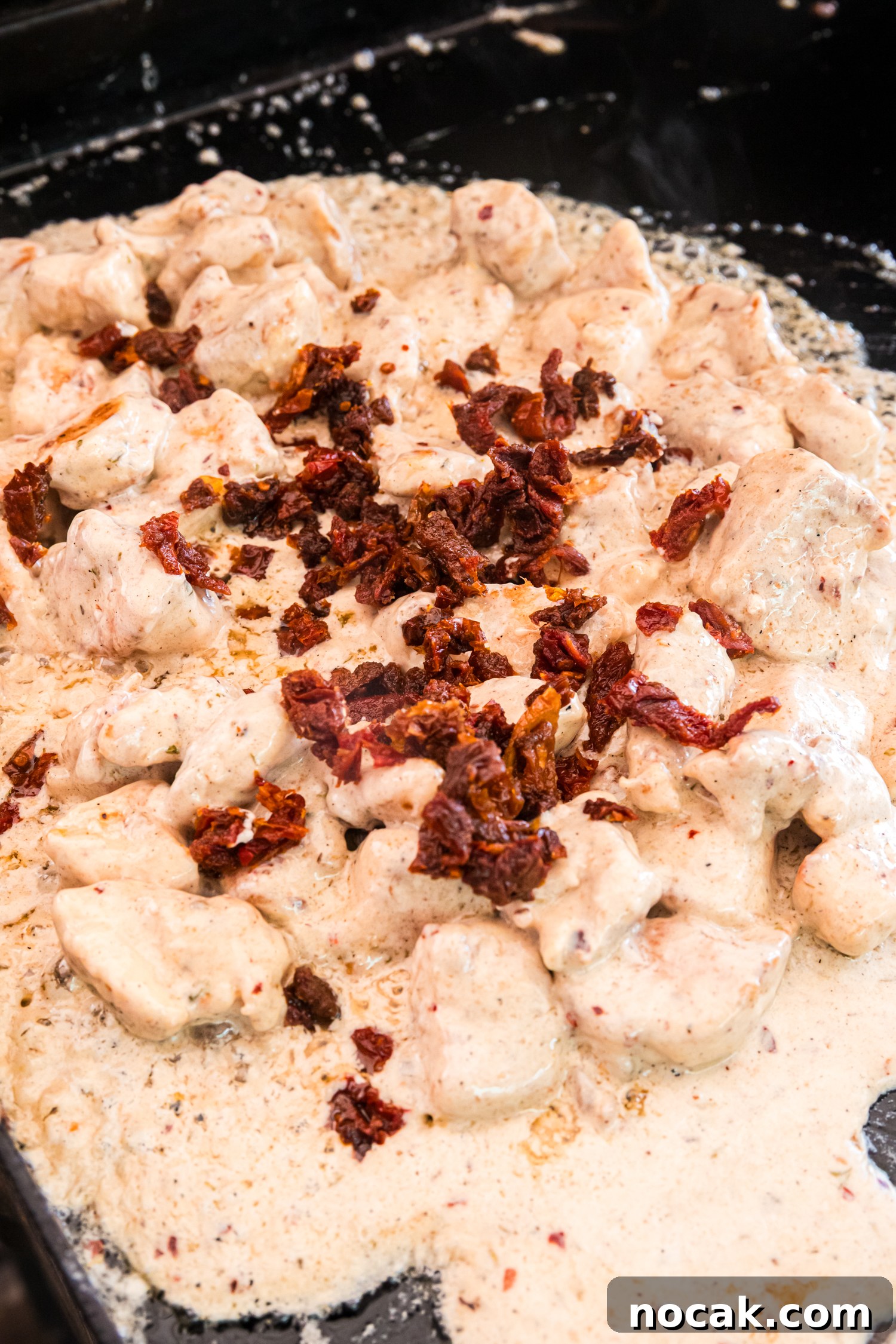 Blackstone Marry Me Chicken Recipe: Skillet Chicken with Creamy Sun-Dried Tomato Sauce 7 Chicken simmers in a creamy sauce on the griddle, topped with chopped sun-dried tomatoes as the sauce thickens and bubbles.