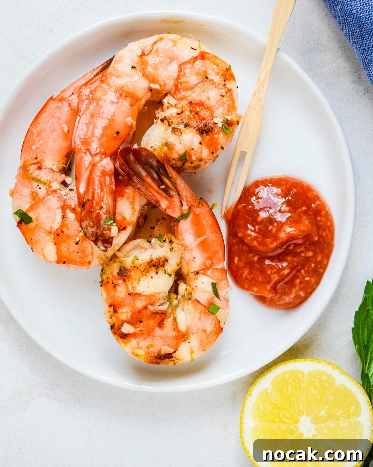 Citrus-Grilled Shrimp Cocktail with Zesty Dipping Sauce 11 An appetizer plate of shrimp and cocktail sauce.