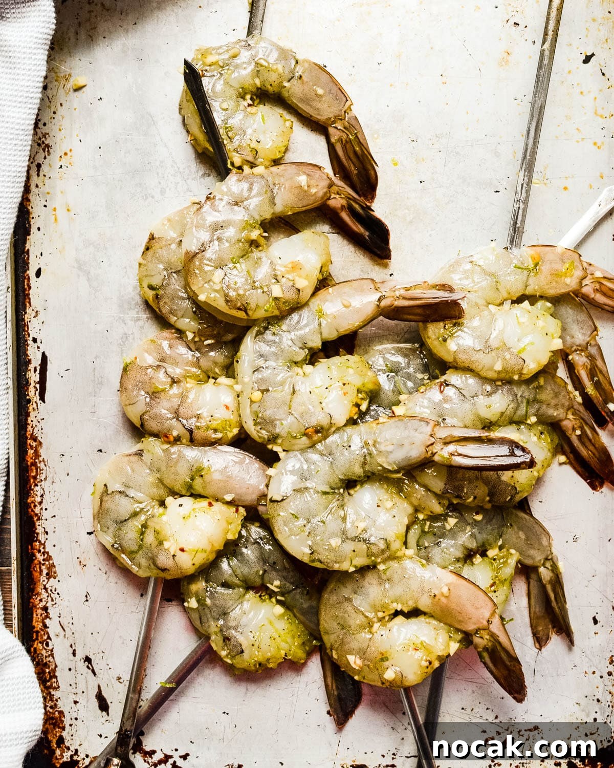 Citrus-Grilled Shrimp Cocktail with Zesty Dipping Sauce 6 A platter of marinated shrimp on skewers.