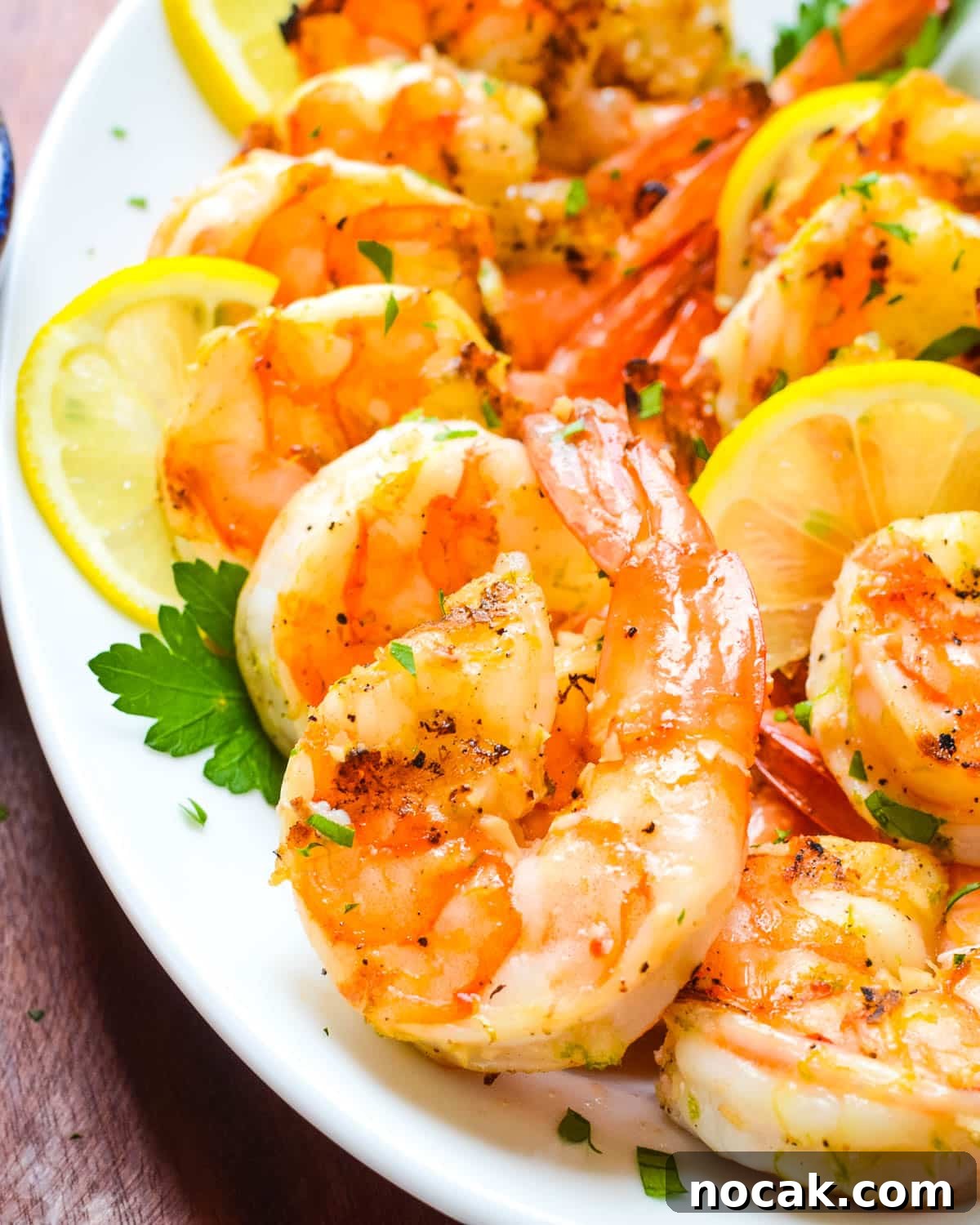 Citrus-Grilled Shrimp Cocktail with Zesty Dipping Sauce 8 A platter of grilled shrimp with lemon slices.