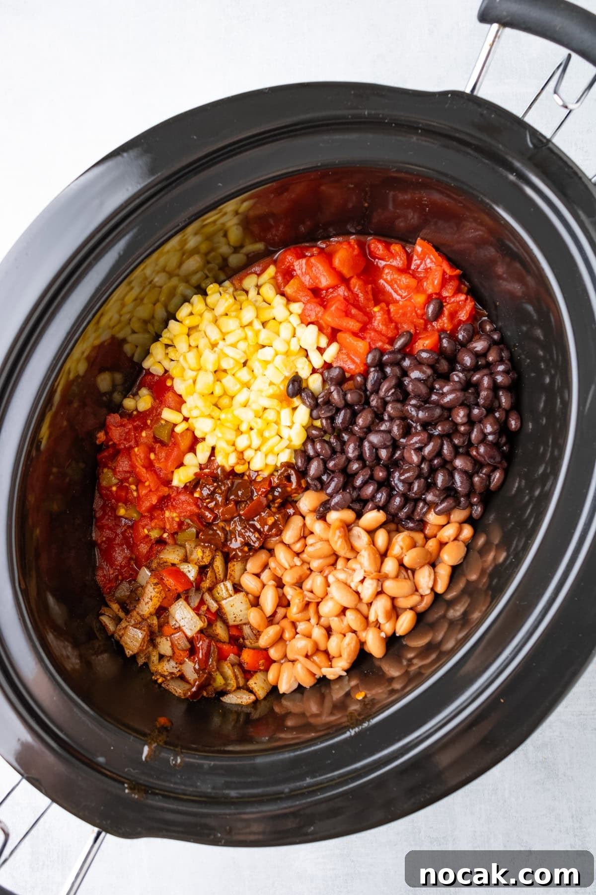 An overhead image of adding the ingredients to the slow cooker.