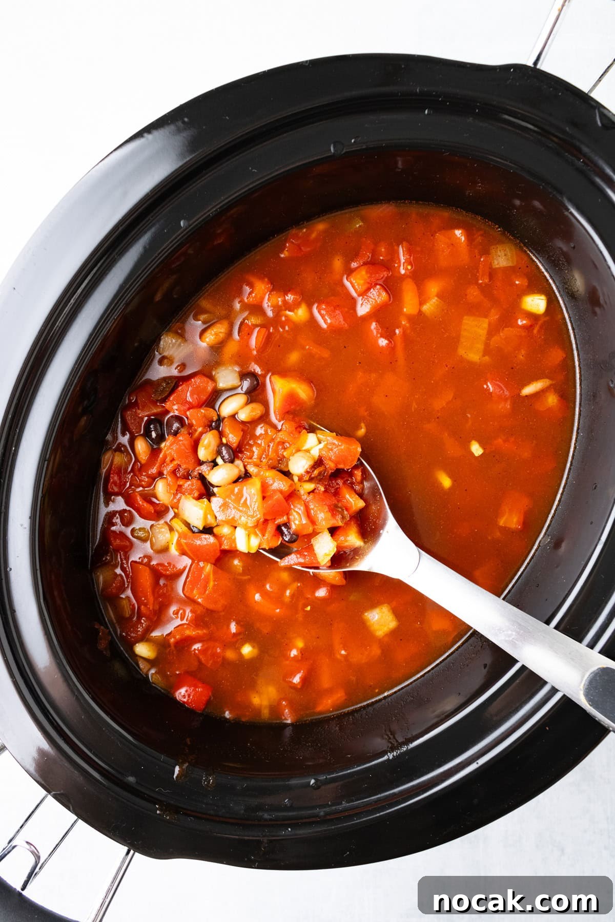 An overhead image of cooking the soup in a slow cooker.