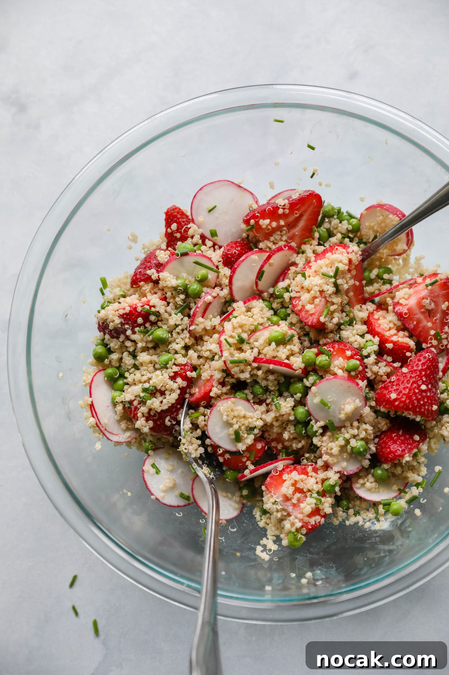 Strawberry Quinoa Salad with Zesty Lime tahini dressing mixed in large mixing bowl 