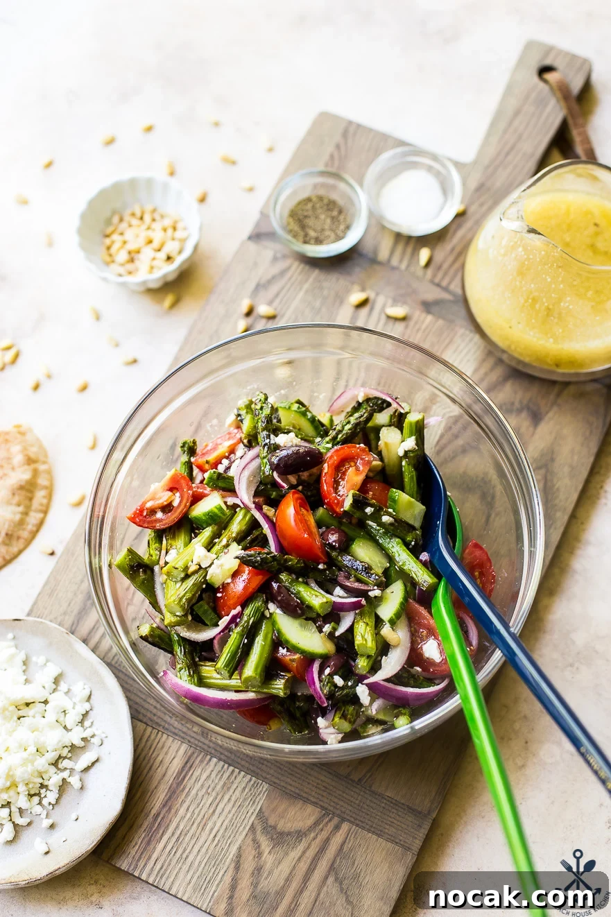 Overhead photo of glass bowl filled with grilled asparagus salad