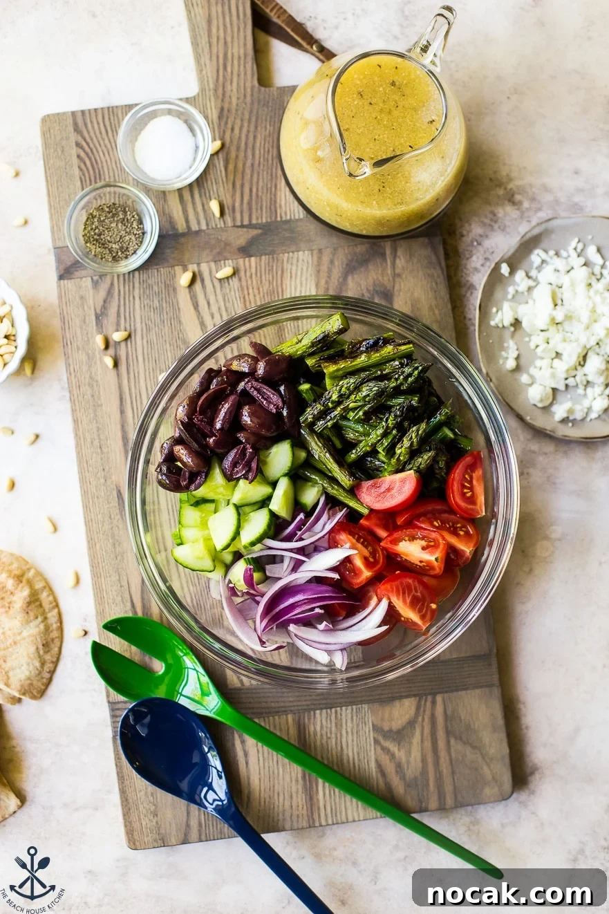 Overhead photo of ingredients for grilled asparagus salad in a glass bowl
