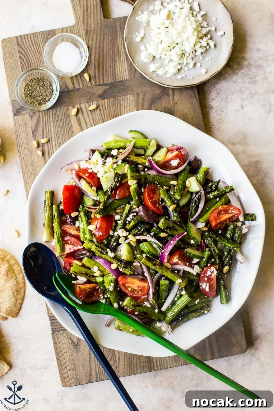 Overhead photo of grilled asparagus salad on a round white plate