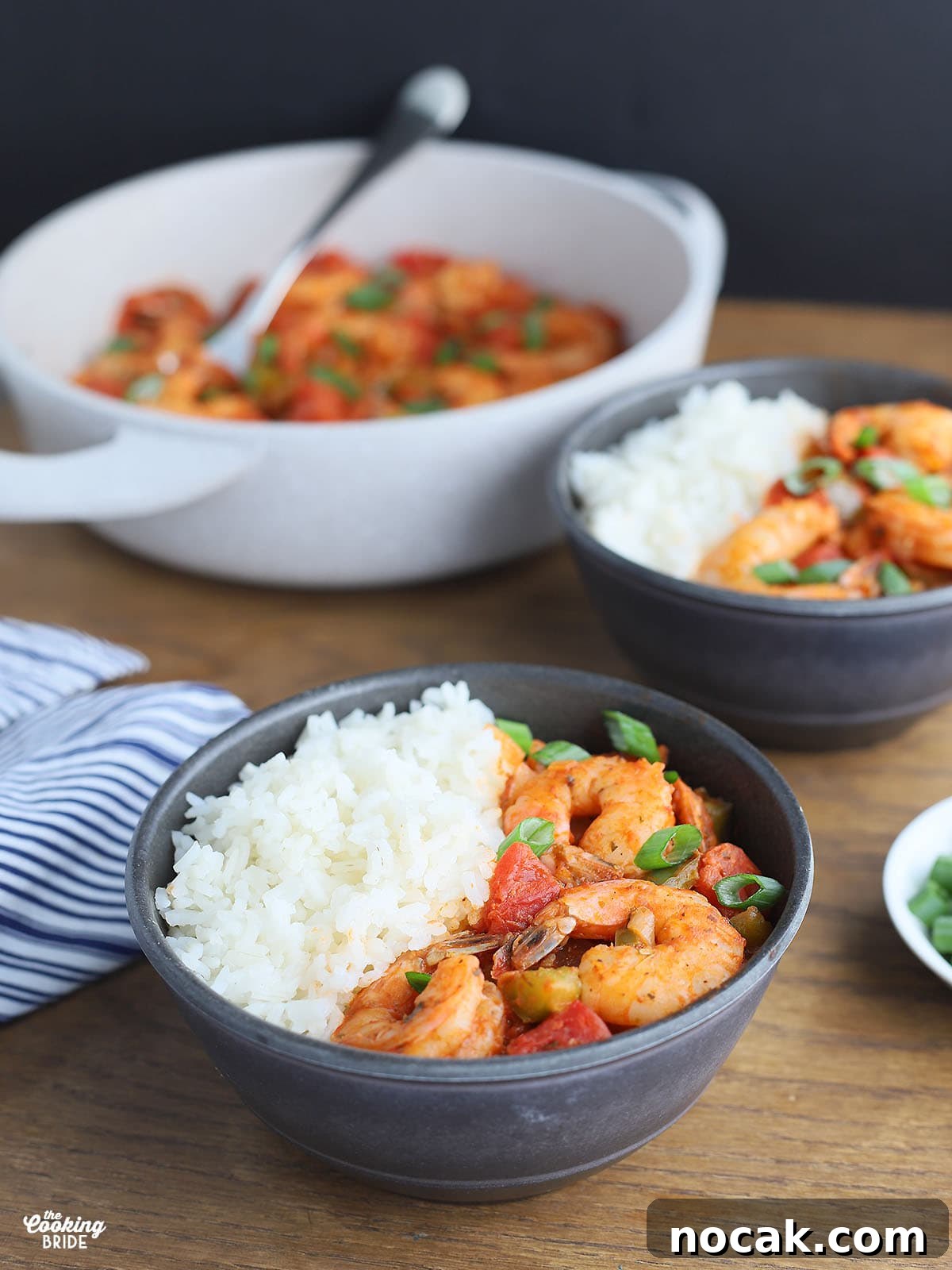 Authentic Louisiana Shrimp Creole Recipe — Classic Creole Flavor 8 individual serving of shrimp creole and rice in a gray serving bowl