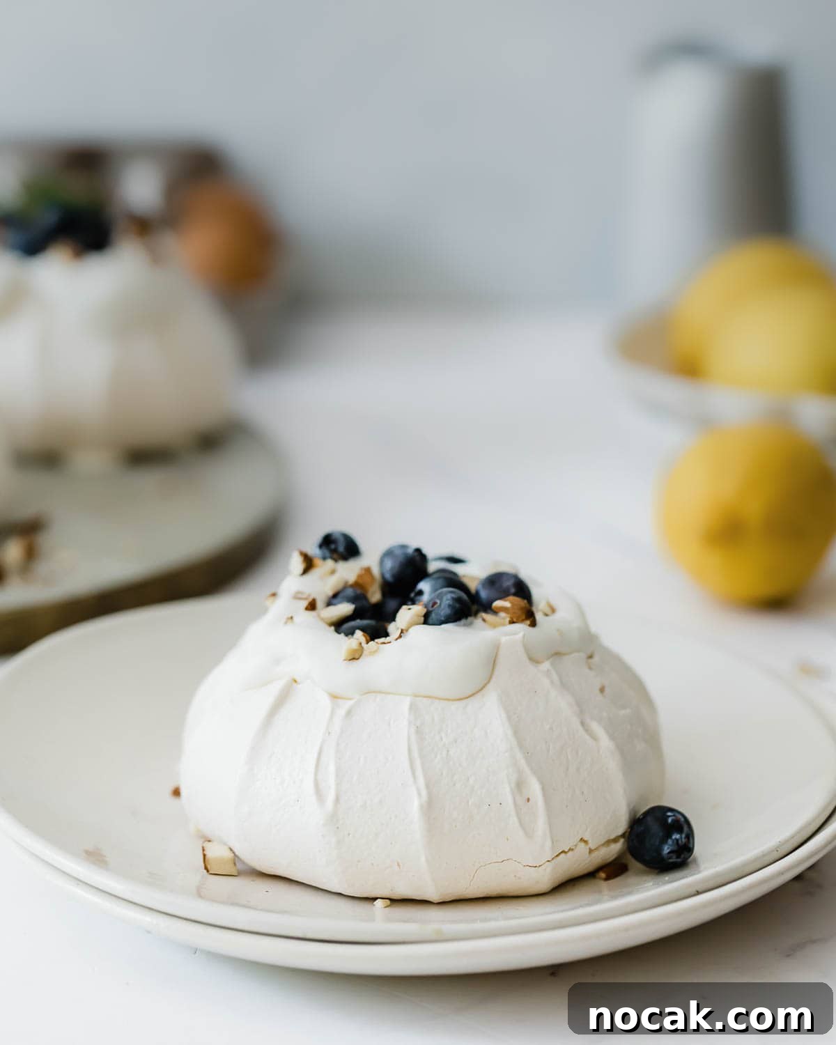 Mini Pavlova Nests Recipe: Crispy Meringue Nests with Berries 4 A single mini pavlova served on a small dessert plate.