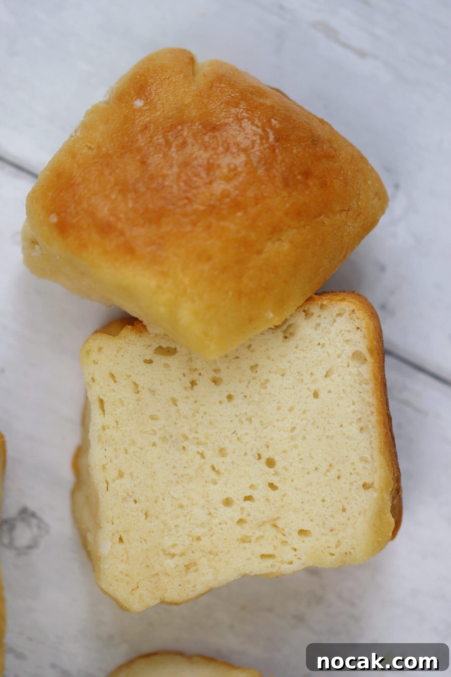 Gluten-Free Hawaiian Rolls Recipe: Soft, Sweet, and Vegan Option 11 A Hawaiian roll cut in half.