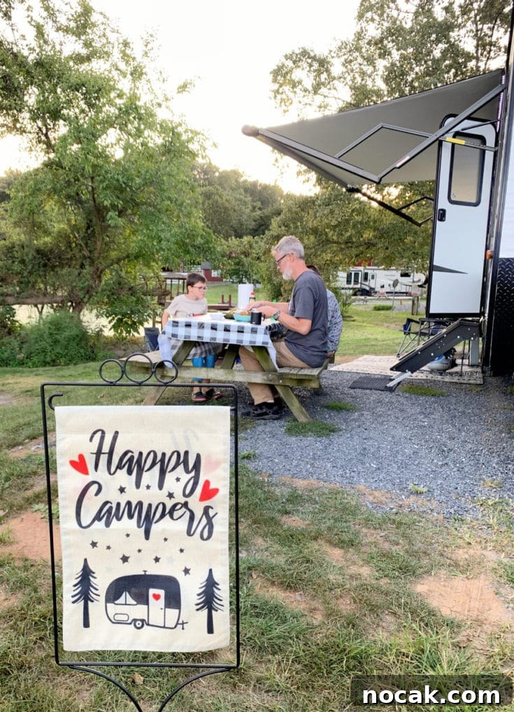 What We Learned After One Year Living in an RV 2 Happy RV Campers flag with family eating near RV in the background
