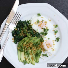 Poached Eggs with Avocado, Spinach and Crispy Quinoa 6 Poached eggs with avocado, spinach & crispy quinoa on a white plate with a knife and fork and on a black background