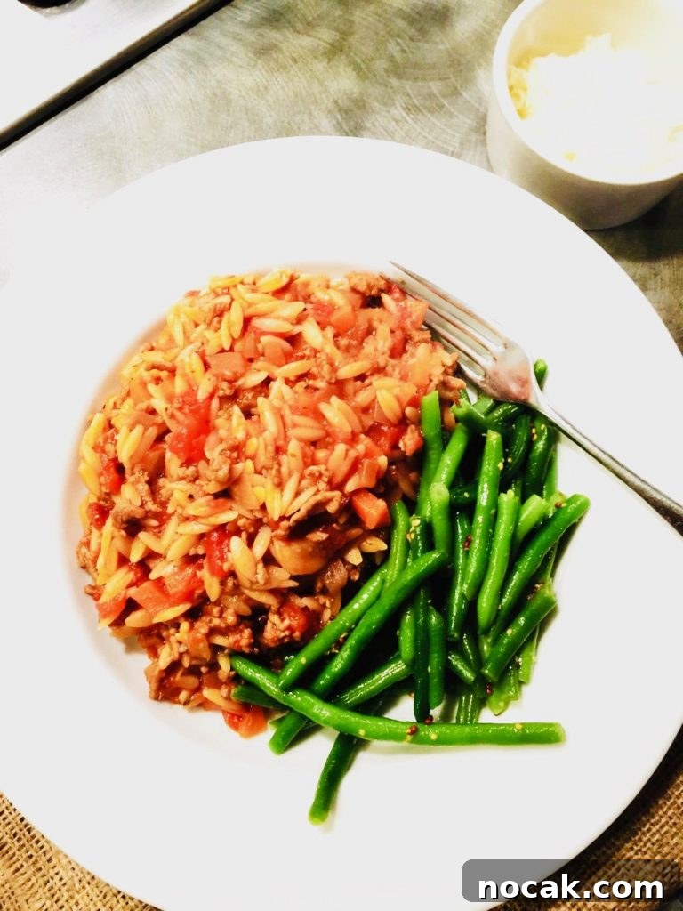 One-Pot Orzo Bolognese Recipe for Flavorful Weeknight Dinners 2 one pot orzo beef bolognese served with green beans