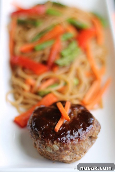 Hoisin-Glazed Mini Meatloaf Muffins Over Asian Noodles & Veggies 9 Plated mini meatloaf with noodles