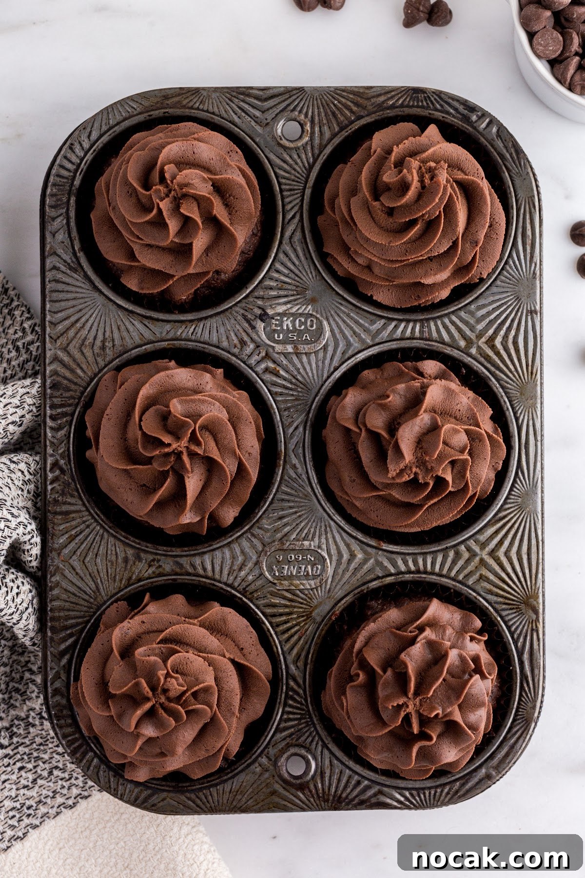 Fudgy Brownie Cupcakes with Gooey Chocolate Centers 13 Frosted cupcakes in the cupcake tin.