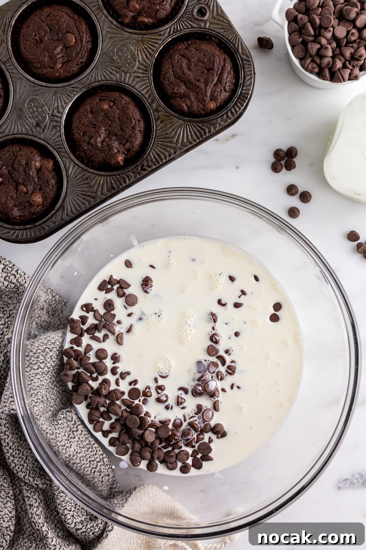 Fudgy Brownie Cupcakes with Gooey Chocolate Centers 10 Mixing the frosting ingredients together in a bowl with the cupcakes off to the side.