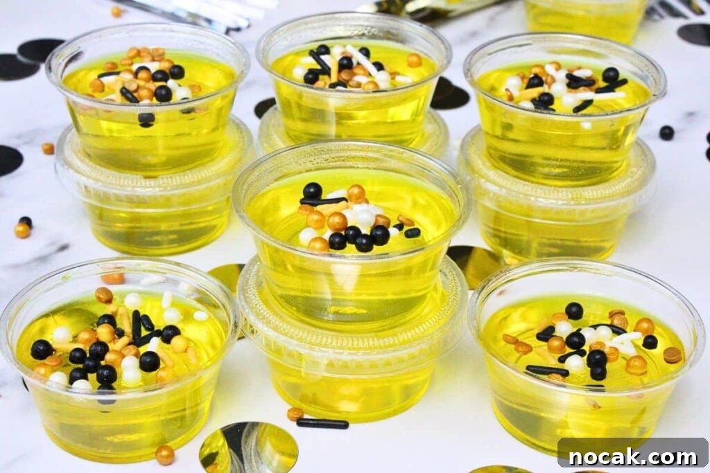 French 75 Jello Shots for a Sparkling New Year’s Party 9 closeup of french 75 jello shots lined and stacked up showing off festive sprinkles on top