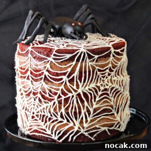 Spiderweb Red Velvet Cake with Chocolate Cream-Cheese Frosting 4 Spiderweb Naked Red Velvet Cake on a black cake stand.