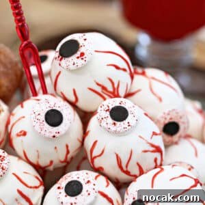 Spiderweb Red Velvet Cake with Chocolate Cream-Cheese Frosting 2 Close-up of Donut Hole Eyeballs.
