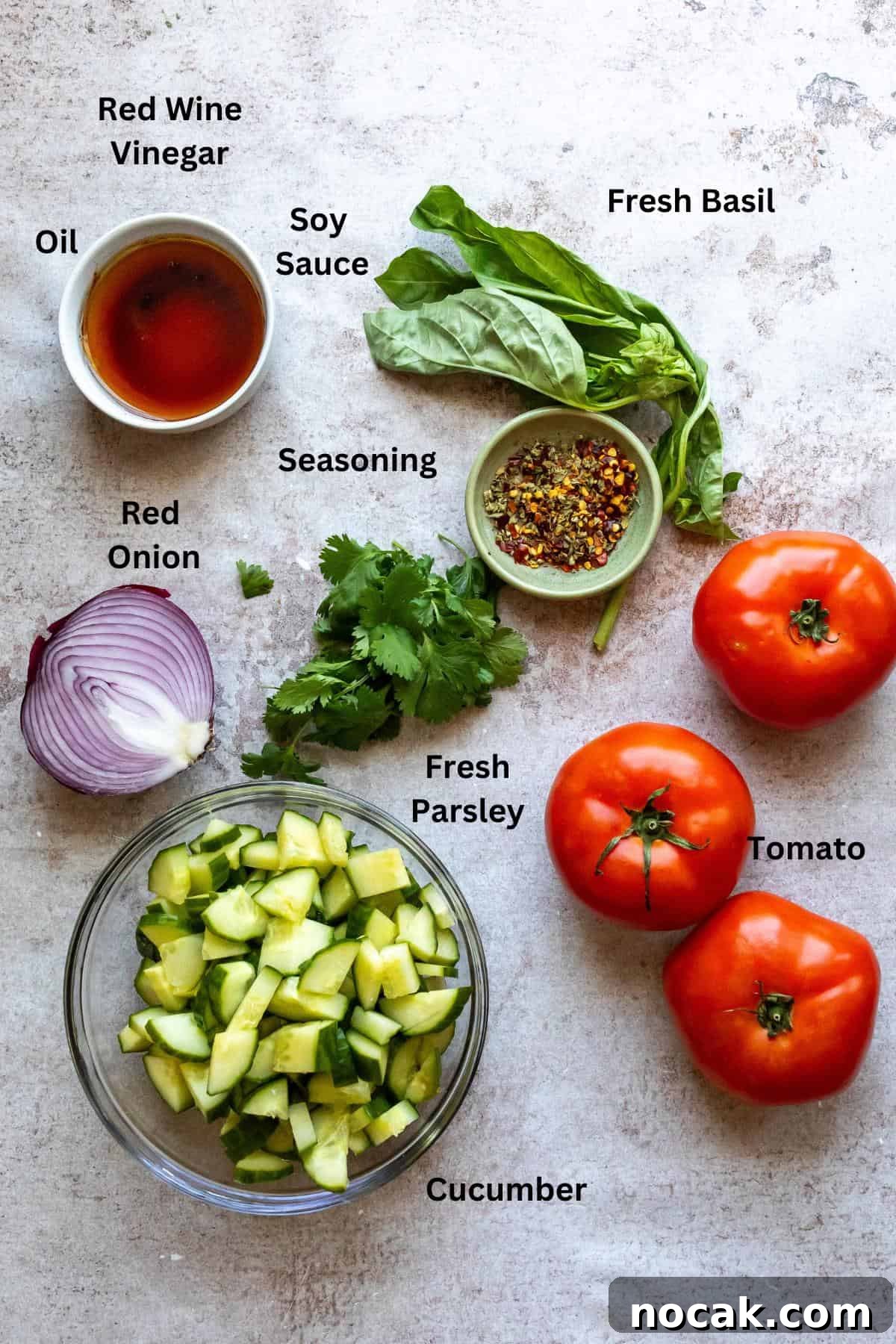 Cucumber and Tomato Salad with Fresh Herbs and Lemon Dressing 3 Ingredients needed to make the salad on a counter.