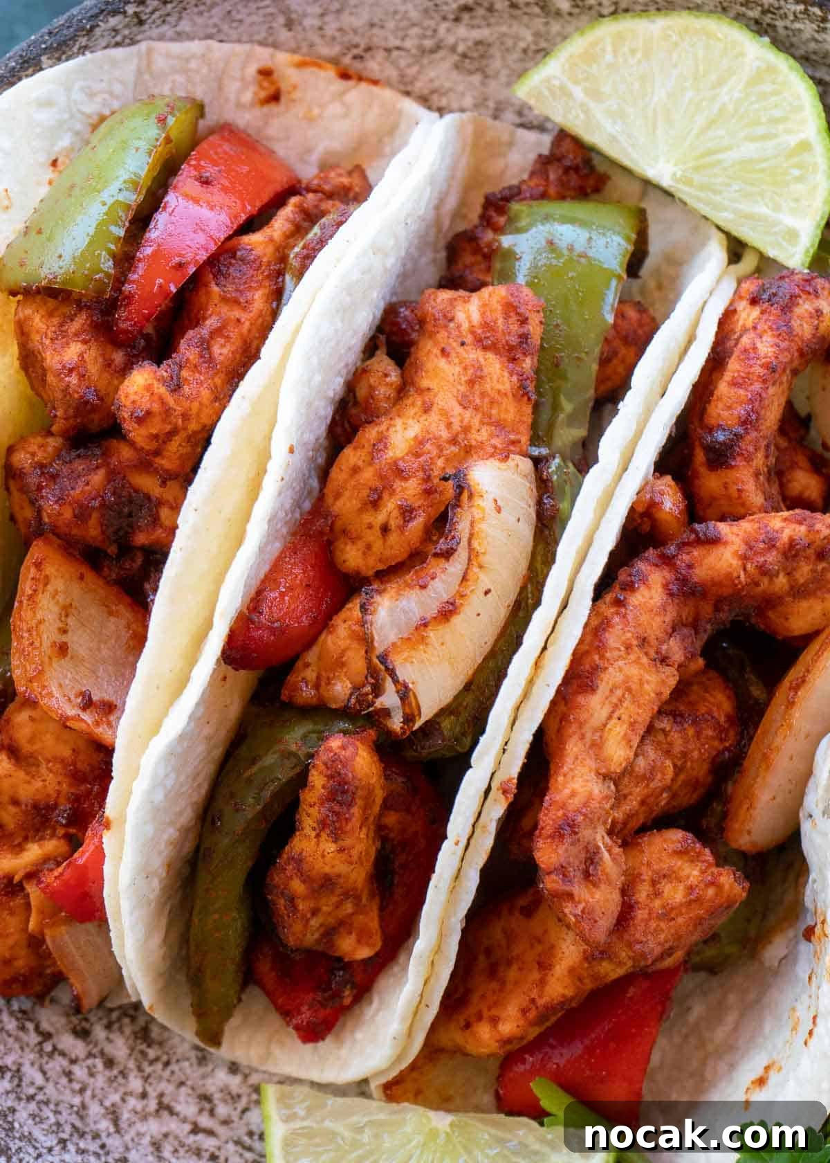 Crispy Air Fryer Chicken Fajitas with Peppers and Onions 3 chicken fajitas on plate