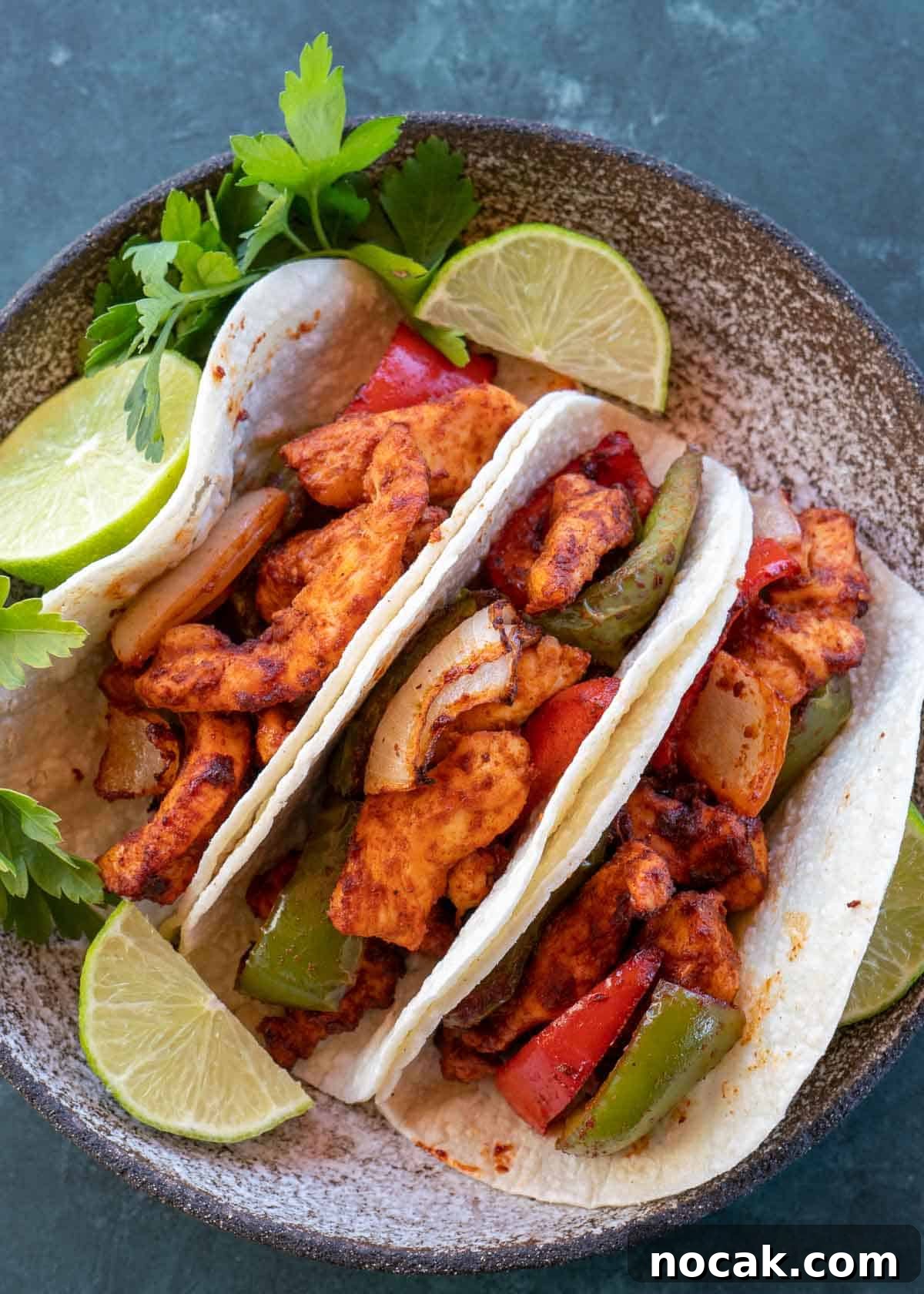 Crispy Air Fryer Chicken Fajitas with Peppers and Onions 4 chicken fajitas on plate