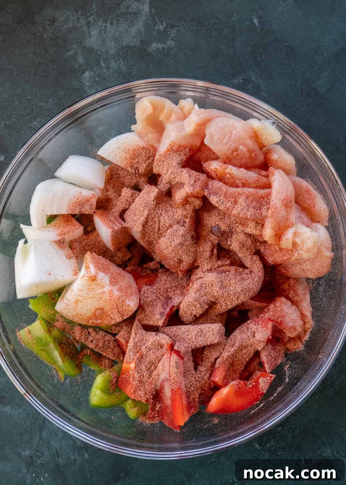 Crispy Air Fryer Chicken Fajitas with Peppers and Onions 6 chicken, peppers, onions and spices in bowl