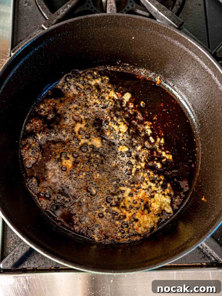 Garlic sizzling in a pan with butter and oil.