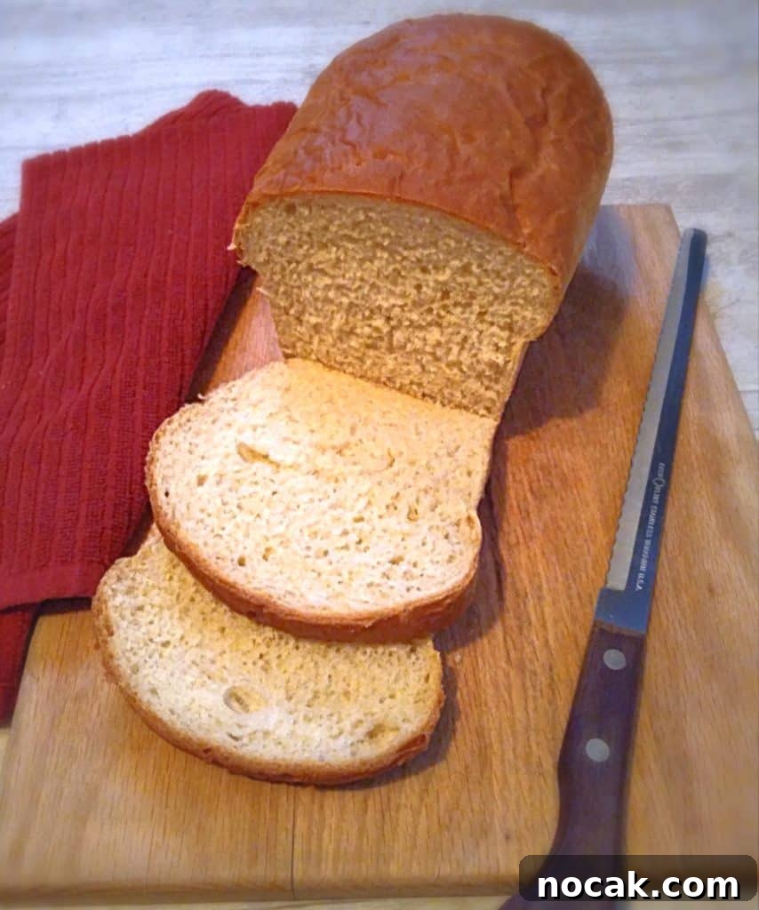 Homemade Amish White Bread: Classic Soft Loaf Recipe 4 Amish homemade bread on a board with a bread knife and two pieces sliced.