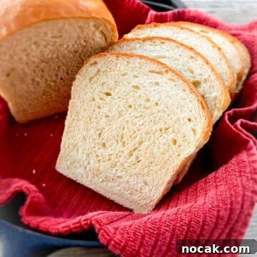 Homemade Amish White Bread: Classic Soft Loaf Recipe 6 sliced homemade Amish bread in a skillet with a red towel along with part of a loaf.