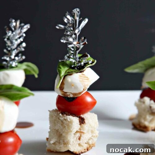 Caprese Skewers Recipe: Fresh Tomato, Mozzarella & Basil Bites 7 close up of caprese skewers on a white plate