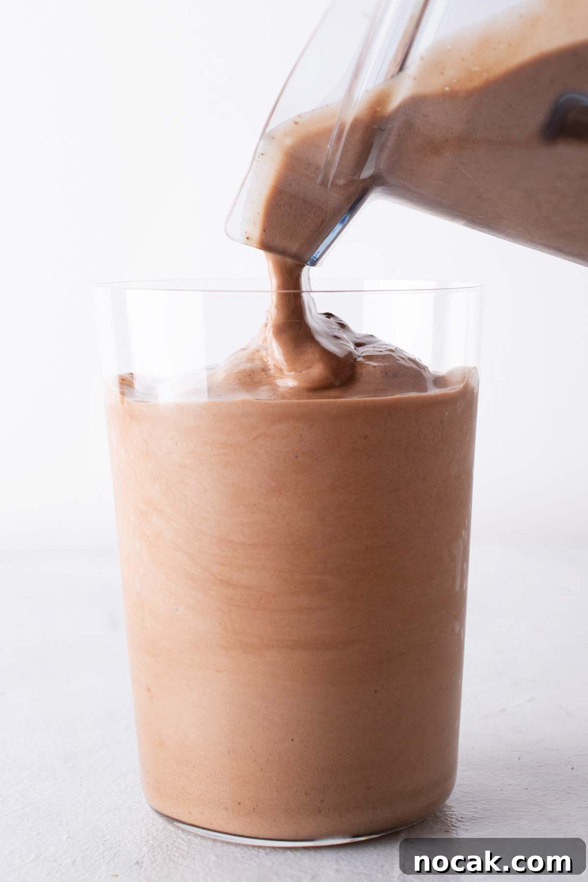 Pouring frappuccino in a cup. 