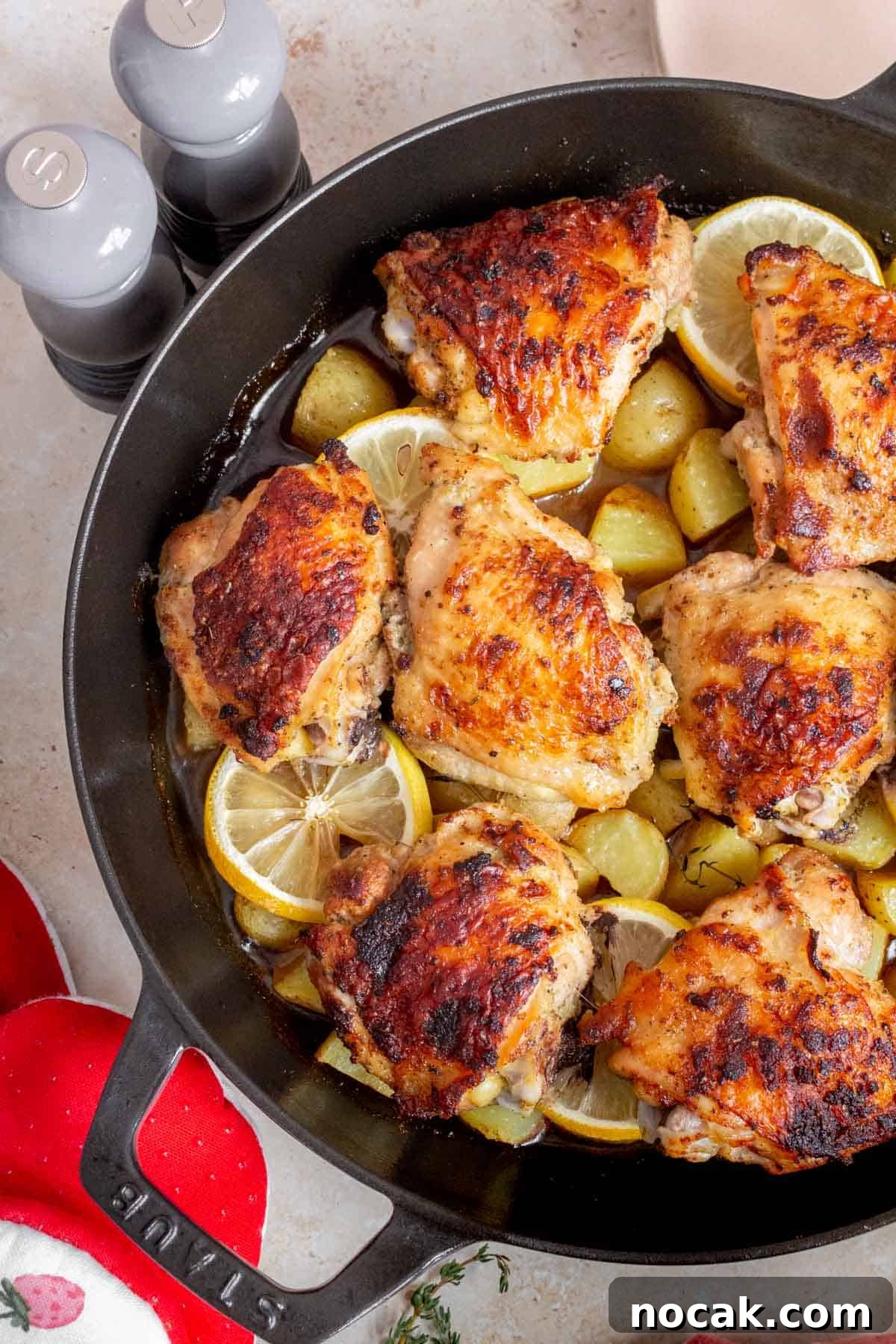 Crispy Cast-Iron Chicken Thighs with Roasted Potatoes 8 A close up view of an overhead view of cast iron chicken thighs and potatoes.