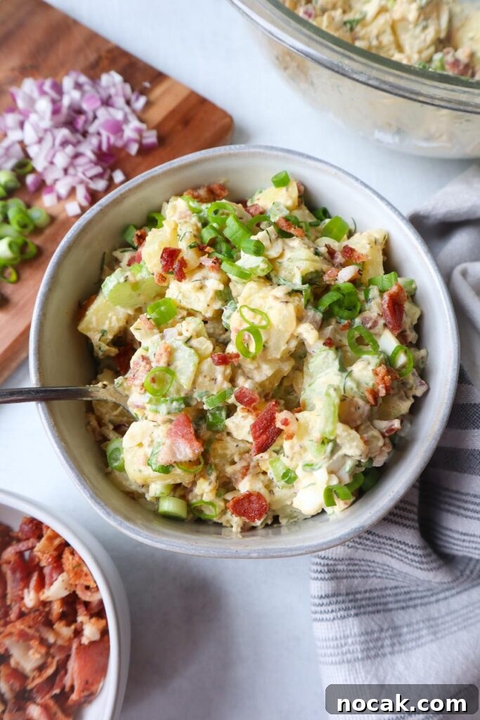 Creamy Potato Salad with Spring Onions and Tangy Dressing 2 bowl with potato salad topped with spring onions and bacon