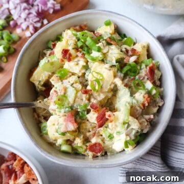 Creamy Potato Salad with Spring Onions and Tangy Dressing 12 bowl with potato salad topped with spring onions and bacon