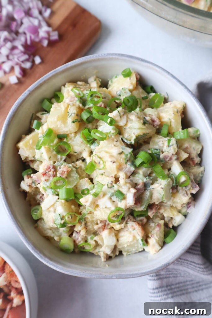 Creamy Potato Salad with Spring Onions and Tangy Dressing 6 bowl with potato salad topped with spring onions