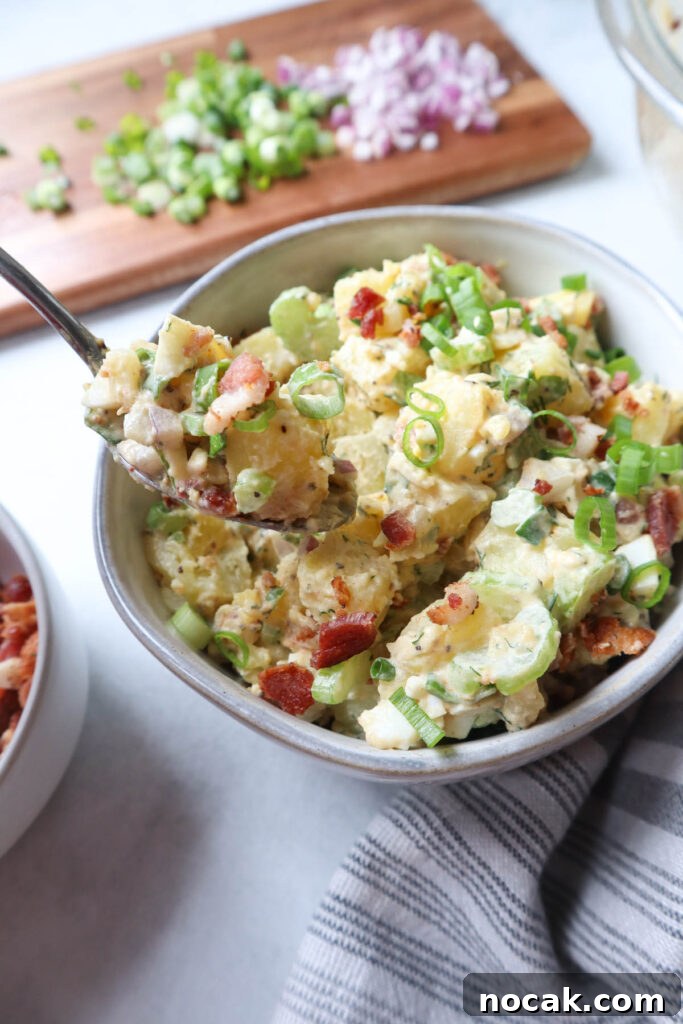 Creamy Potato Salad with Spring Onions and Tangy Dressing 7 bowl with potato salad topped with spring onions and bacon