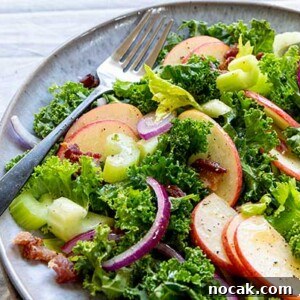 Kale Apple Salad on a gray plate with a silver fork