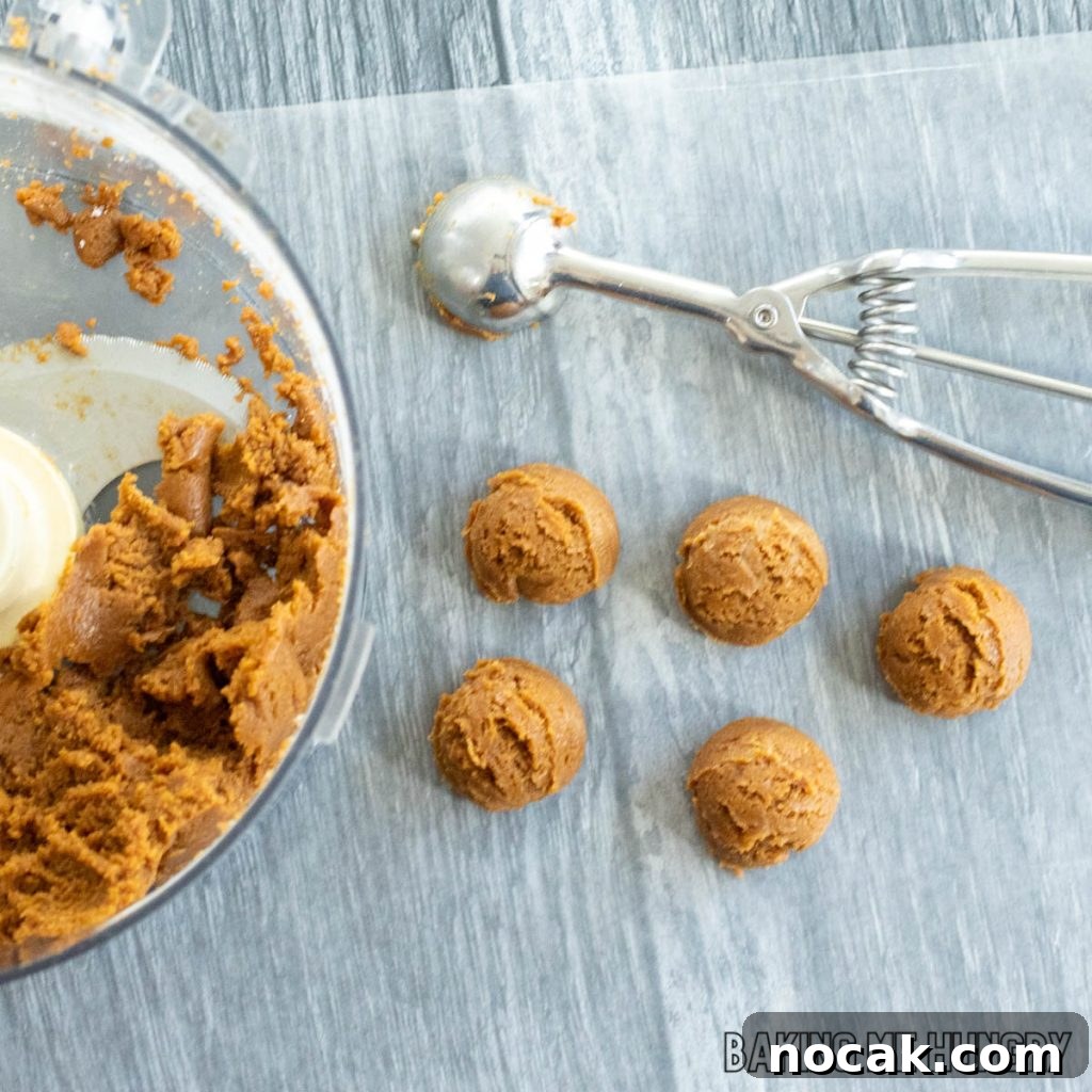 cookie scoop next to balls of dough
