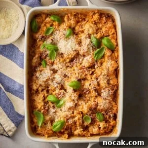 Marry Me Chicken and Rice — One-Pan Dump and Bake Recipe 14 A dish filled with creamy Marry Me Chicken and Rice, ready to serve on a table.