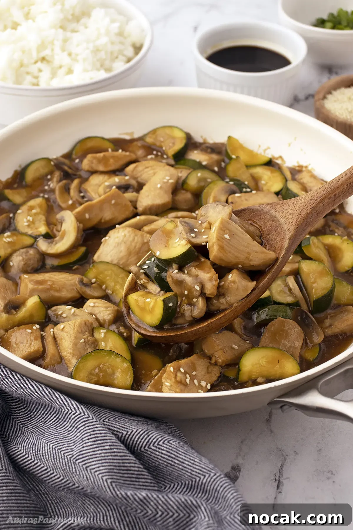 A spoon scooping some of the mushroom chicken skillet.