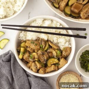 An overhead image with a rice bowl topped with some panda express chicken.