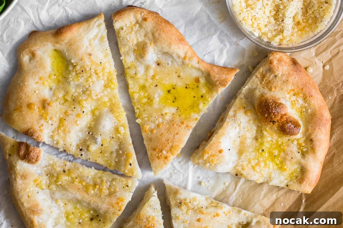 Cacio e Pepe Pizza Recipe — 4-Ingredient Weeknight Dinner 2 sliced cacio e pepe pizza on parchment paper