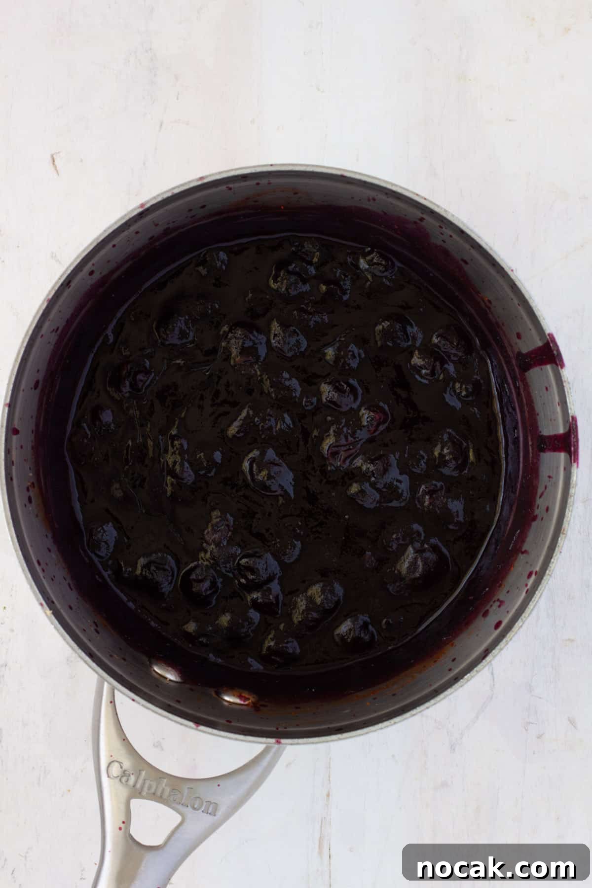 Blueberry bbq sauce cooking in a medium saucepan.