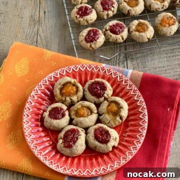 Jam Thumbprint Cookies: Baking Memories at a Cookie Party 5 jam thumbprints on red plate with more on cooling rack in background