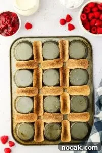 Raspberry Cheesecake Tacos: Creamy Dessert Taco Recipe 16 mini taco shells coated in sweet mixture placed in between upside muffin tin