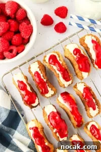 Raspberry Cheesecake Tacos: Creamy Dessert Taco Recipe 20 wire cooling rack topped with multiple raspberry cheesecake mini tacos