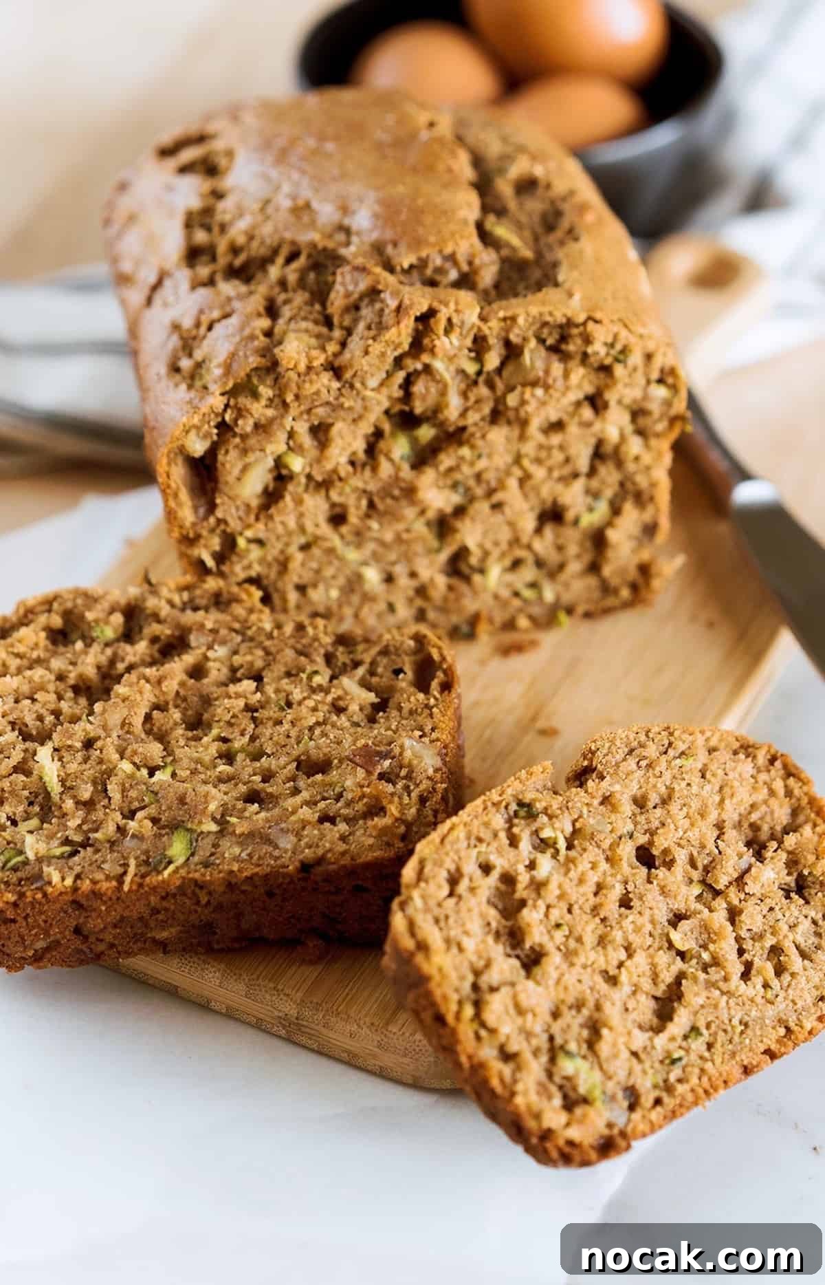 Moist Zucchini Bread with Greek Yogurt — No Squeezing Needed 5 sliced zucchini bread with eggs in background