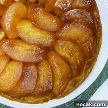 Tarte Tatin with caramelized apples packed on top of puff pastry.