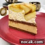 A single slice of apple mousse cake on a red dessert plate with a tea set.