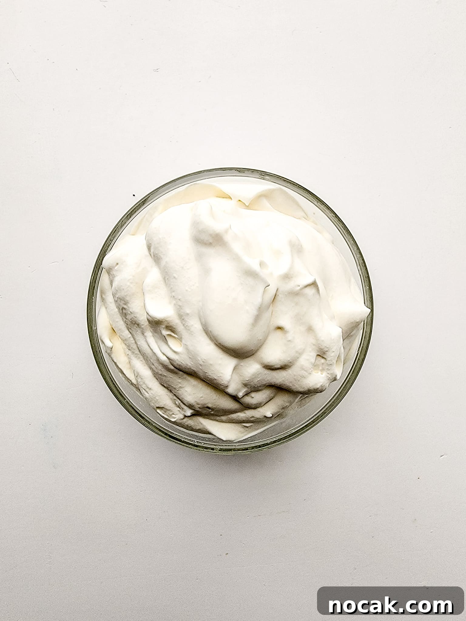 DIY S'mores Frappuccino: Starbucks Copycat Recipe for Home 4 Glass mixing bowl with heavy whipping cream mixture fully mixed.